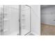 Modern shower with glass enclosure and built-in shelving, next to a large walk in closet at 1748 Post Oak Dr, Haw River, NC 27258