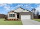 Charming single-story home with brick and siding exterior, complemented by a well-maintained front lawn at 1749 Post Oak Dr, Haw River, NC 27258