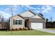 Inviting single-Gathering home featuring a brick-accented facade, a two-car garage, and a green lawn at 1749 Post Oak Dr, Haw River, NC 27258