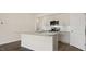 Elegant kitchen showcasing an island, stainless steel appliances, bright cabinets, and stylish backsplash at 1749 Post Oak Dr, Haw River, NC 27258