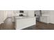 Stylish kitchen boasts an island, stainless steel appliances, white cabinets, and plenty of space for cooking at 1749 Post Oak Dr, Haw River, NC 27258