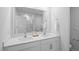 Bathroom featuring double sinks with white cabinets and a large mirror at 1914 Frost Dr, Haw River, NC 27258