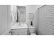 Bathroom with white cabinets, a striped shower curtain, and a houseplant at 1914 Frost Dr, Haw River, NC 27258