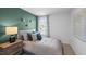 Cozy bedroom with a green accent wall and a view of the outside at 1914 Frost Dr, Haw River, NC 27258