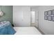 Bright bedroom featuring white doors, neutral carpet, and tasteful botanical-themed wall decorations at 1914 Frost Dr, Haw River, NC 27258
