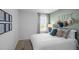 Stylishly decorated bedroom features natural light, decorative pillows, and unique wall art at 1914 Frost Dr, Haw River, NC 27258