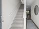 Inviting entryway featuring carpeted stairs and an open view to the living area at 1914 Frost Dr, Haw River, NC 27258
