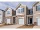 Townhouse with a beige exterior, brick accents, and an attached one car garage at 1916 Frost Dr, Haw River, NC 27258