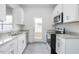Modern kitchen featuring white cabinets, granite countertops, and stainless steel appliances at 1916 Frost Dr, Haw River, NC 27258