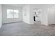Open concept room with neutral paint and laminate flooring at 1916 Frost Dr, Haw River, NC 27258