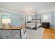 Main bedroom features a four poster bed frame, fluffy rug, and nice natural lighting at 2605 Ridge Rd, Raleigh, NC 27612