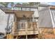 Back porch with ceiling fan and a wood railing, stairs, and deck area for backyard relaxation at 2623 Broad Oaks Pl, Raleigh, NC 27603