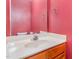 Half bath featuring a bright red wall and a white countertop at 2623 Broad Oaks Pl, Raleigh, NC 27603