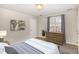 Cozy bedroom featuring carpet, a dresser, artwork, and a large window at 2623 Broad Oaks Pl, Raleigh, NC 27603
