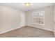 Neutral bedroom with carpet, a window, and a door leading to a closet at 2623 Broad Oaks Pl, Raleigh, NC 27603