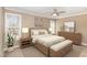 Staged bedroom with a decorative ceiling fan, two windows and stylish furnishings at 2623 Broad Oaks Pl, Raleigh, NC 27603
