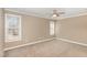 Spacious bedroom with neutral walls, carpet, a ceiling fan, and two large windows at 2623 Broad Oaks Pl, Raleigh, NC 27603