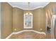 Bright breakfast nook featuring large windows, laminate flooring, and classic chandelier lighting at 2623 Broad Oaks Pl, Raleigh, NC 27603