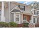 Exterior view showcasing a charming two-story home with brick accents, black shutters, and snowy ground at 2623 Broad Oaks Pl, Raleigh, NC 27603