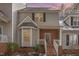 Charming two-story home with a brick facade and bay window with snowy landscape at sunset at 2623 Broad Oaks Pl, Raleigh, NC 27603