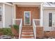 Inviting front porch with brick steps, white railings, and a brick facade adds curb appeal at 2623 Broad Oaks Pl, Raleigh, NC 27603