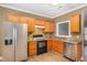 Functional kitchen boasts stainless steel appliances, ample cabinet space, and durable laminate flooring at 2623 Broad Oaks Pl, Raleigh, NC 27603
