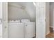 Laundry room with a washer, a dryer, and a metal shelf above at 2623 Broad Oaks Pl, Raleigh, NC 27603