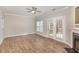 Spacious living room with hardwood floors, ceiling fan, and a view to an outdoor patio at 2623 Broad Oaks Pl, Raleigh, NC 27603