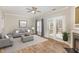 Bright living room featuring a cozy fireplace, neutral color palette, and access to a porch or patio at 2623 Broad Oaks Pl, Raleigh, NC 27603