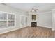 Bright living room with hardwood floors, a ceiling fan, and a cozy fireplace at 2623 Broad Oaks Pl, Raleigh, NC 27603