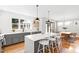 Modern kitchen featuring a large island, seating, stainless steel appliances, and backyard view at 309 Taylor St, Raleigh, NC 27607