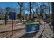 Community playground featuring slides, climbing structures, and posted rules, located in a park setting with mature trees at 309 Taylor St, Raleigh, NC 27607