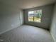 Bedroom with window providing a view of the yard and neighborhood at 312 Chesapeak Commons St # 144, Garner, NC 27529
