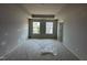 Neutral bedroom with two windows providing neighborhood views at 312 Chesapeak Commons St # 144, Garner, NC 27529