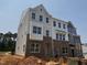New construction townhome showcasing brick and siding facade with large windows at 312 Chesapeak Commons St # 144, Garner, NC 27529