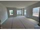 Living room featuring large windows and neutral color scheme at 312 Chesapeak Commons St # 144, Garner, NC 27529