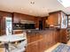 Spacious kitchen featuring wooden cabinetry, a black tiled backsplash, and an island with seating at 3206 Sussex Rd, Raleigh, NC 27607