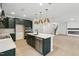 Kitchen featuring large center island with seating, dark green cabinets, and open layout at 3279 Roundly Rd # 11, New Hill, NC 27562