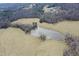 Attractive aerial view featuring a placid pond nestled within expansive pastoral land at 3344 Cobb Farm Trl, Mebane, NC 27302