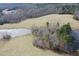 Panoramic aerial shot showcasing the property's rolling fields, ponds, and wooded areas at 3344 Cobb Farm Trl, Mebane, NC 27302