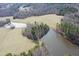 Aerial view of two ponds, surrounded by trees and a grassy area at 3344 Cobb Farm Trl, Mebane, NC 27302