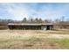 Spacious barn with metal roof and open side showcasing the surrounding field at 3344 Cobb Farm Trl, Mebane, NC 27302