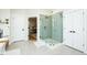 Modern bathroom featuring a glass shower with green tile, white cabinets and gray tile floor at 3344 Cobb Farm Trl, Mebane, NC 27302