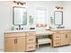 Close-up of bathroom vanities with makeup area featuring white countertops and light wood cabinetry at 3344 Cobb Farm Trl, Mebane, NC 27302