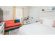 A cozy bedroom with a bed, a play kitchen, and a colorful couch at 3344 Cobb Farm Trl, Mebane, NC 27302