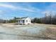 Cozy cottage-style home with a charming front porch, gravel yard, and serene surroundings at 3344 Cobb Farm Trl, Mebane, NC 27302