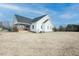 Charming white farmhouse with a welcoming front porch and ample space for firewood storage at 3344 Cobb Farm Trl, Mebane, NC 27302