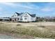 Expansive farmhouse with wraparound porch, showcasing classic American charm and curb appeal at 3344 Cobb Farm Trl, Mebane, NC 27302