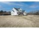 Charming two-story farmhouse with a covered front porch and a spacious yard at 3344 Cobb Farm Trl, Mebane, NC 27302
