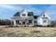 Charming two-story home with a inviting front porch, American flag and well-maintained lawn at 3344 Cobb Farm Trl, Mebane, NC 27302
